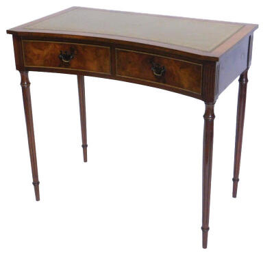 A mahogany writing table, the top with a green leather inset and a concave front, above two frieze drawers, on turned fluted legs, 85cm wide.