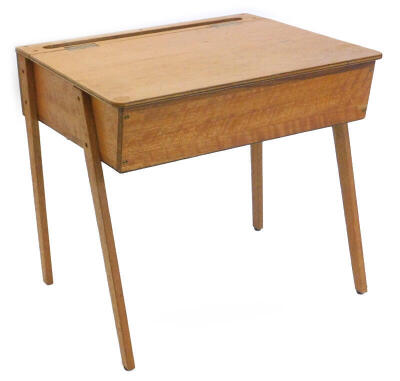 A mid to late 20thC child's desk, with a hinged lid enclosing a vacant interior, on shaped legs, 65cm wide.