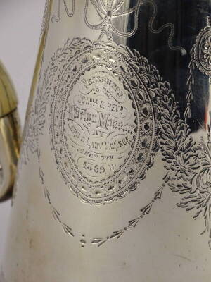 A George II silver coffee pot, of tapering form, later engraved overall with ribbons, leaves and flowers, inscribed 'presented to the Honourable and Reverend Evelyn Monson by Lord and Lady Monson Aug 7th 1860,' with a shaped ivory handle, London 1731, mak - 2