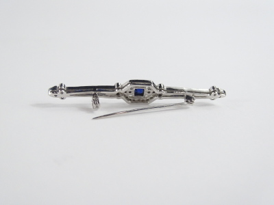 An Art Deco sapphire & diamond bar brooch, set with central square cut blue sapphire 3mm x 3mm, surrounded by twenty four round brilliant cut diamonds, and with a further four diamonds to each end, each approx 1mm diameter, totalling approx 0.15cts overal - 2