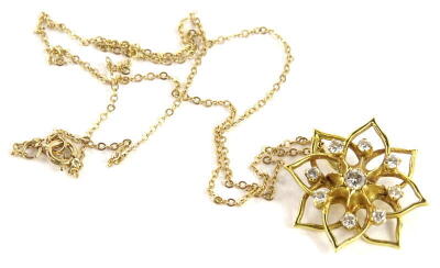 An 18ct gold floral diamond pendant and chain, with openwork flower design, set to the centre with one single round brilliant cut diamond, approx 3.2mm diameter, surrounded by eight smaller stones, each approx 2.2mm, total overall estimated carat weight 0