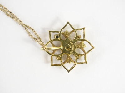 An 18ct gold floral diamond pendant and chain, with openwork flower design, set to the centre with one single round brilliant cut diamond, approx 3.2mm diameter, surrounded by eight smaller stones, each approx 2.2mm, total overall estimated carat weight 0 - 2