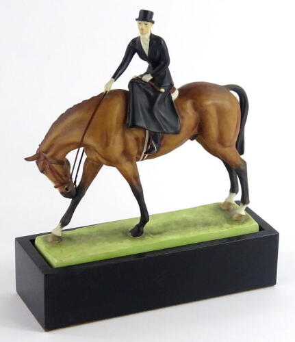 A Royal Worcester porcelain figure, At The Meet, modelled by Doris Lindner, printed mark in black and numbered 3114, on an ebonised stand, 18.5cm wide.