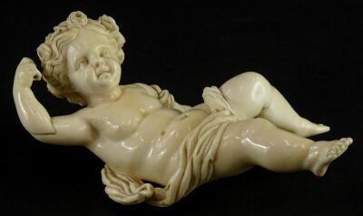 A 19thC carved ivory putto, the head carved with flowers and leaves, lacking wings, etc., 16cm high.