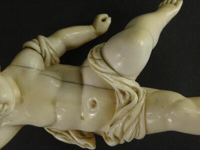 A 19thC carved ivory putto, the head carved with flowers and leaves, lacking wings, etc., 16cm high. - 3