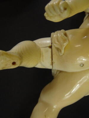 A 19thC carved ivory putto, the head carved with flowers and leaves, lacking wings, etc., 16cm high. - 4