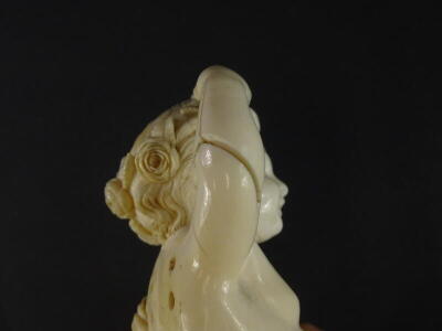 A 19thC carved ivory putto, the head carved with flowers and leaves, lacking wings, etc., 16cm high. - 6