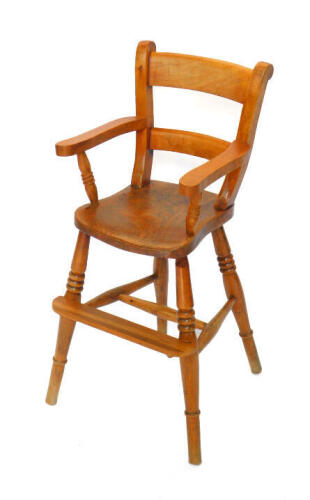 A Victorian beech and elm child's kitchen high chair, with later foot rest.