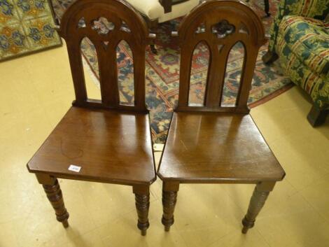 A pair of Victorian mahogany hall chairs