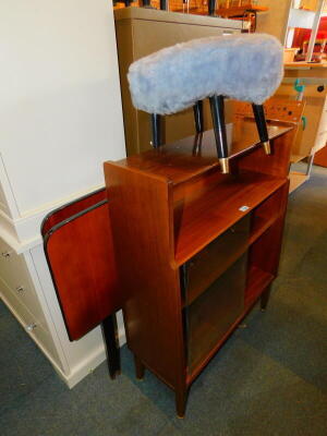 A teak bookcase with glass sliding doors, possibly Nathan, 98cm high, 77cm wide, 28cm deep., together with a Sherborne stool and two bed heads. (4)