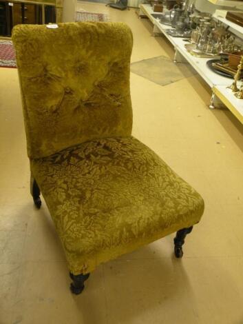 A Victorian nursing chair upholstered in gold patterned fabric