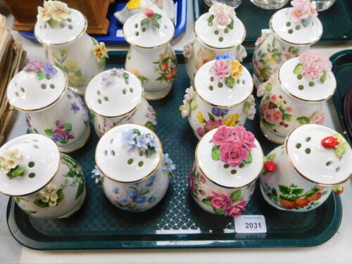 A Royale Stratford Compton & Woodhouse porcelain pot pourri collection, each printed and encrusted with fruit or flowers, together with a wall mounted display rack. (13)