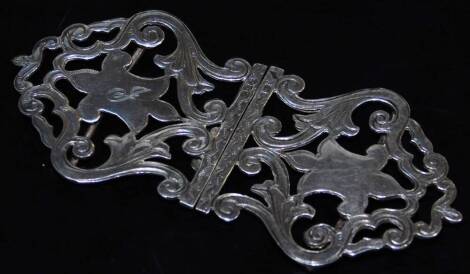 A George V silver two piece buckle, of shaped pierced form with scrolls and central cartouche, initialled in two sections with plain pin back to each piece, Chester probably 1918, 11cm wide, 1.3oz.