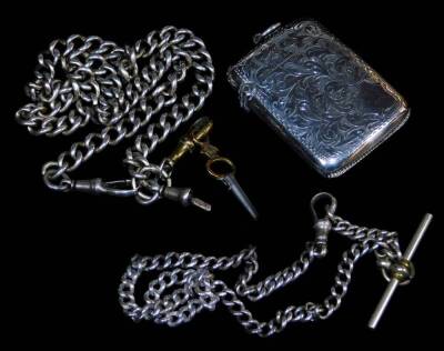 A late Victorian silver vesta case, of oblong form, set with ferns with vacant cartouche and match striker base, with plain hook top, Birmingham 1901, 6cm high, ½oz and a watch chain. (2)