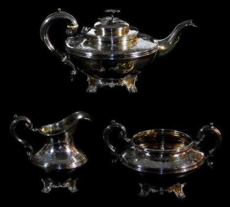 A Victorian silver three piece tea service, by John James Keith, comprising teapot, 15cm high, two handled sugar bowl and milk jug with silver gilt interior, each on quadruple scroll and shell feet, London 1840, 40oz. (3)