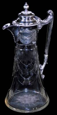 A Victorian style silver plated claret jug, of trumpet shaped form with a repeat cut glass floral pattern and plated mounts, with fluted scroll handle and repeat garland decoration, 30cm high.