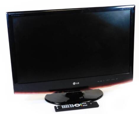 A LG 27 inch HD television, in black with wire and remote control.