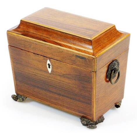 A Regency rosewood tea caddy, of rectangular form with ivory escutcheon, part fitted interior, heavy metal handles on shaped feet, 18cm high, 19cm wide, 12cm deep. (AF)