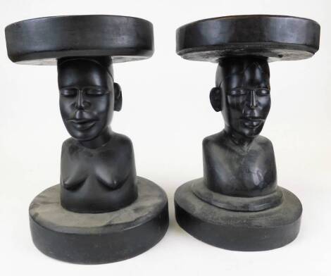 An African tribal stand, with plain circular top, nude quarter length figure stem and plain circular base, unmarked, 45cm high and another similar. (2)