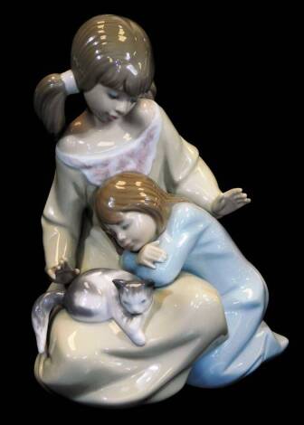 A Lladro figure group of two children and kitten, no. 1354, printed and impressed marks beneath, 17cm high.