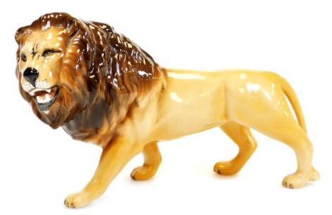 A 20thC Beswick figure of a standing lion, printed marks beneath, 13cm high.