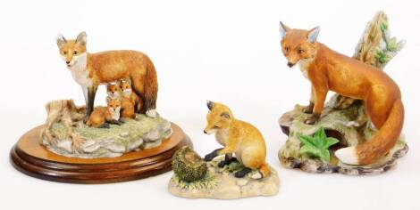 A Kowa porcelain red fox figure group, others, Border Fine Arts fox and another unmarked, on plinth base, 12cm high. (3)