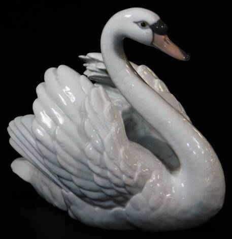 A 20thC Lladro figure of a swan, printed marks beneath, 18cm high.