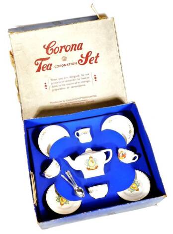 A Corona child's coronation tea set, with ER II transfer printed emblem to include teapot 10cm high, milk jug, plates, etc., partially boxed.