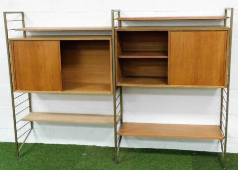 A 1960's teak and metal framed Ladderax open cabinet, with various shelves, open sections and metal stiles with horizontal cylindrical supports, 135cm high.