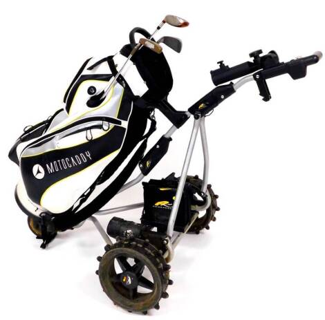 A Motocaddy golf bag, an electric PowaKaddy trolley 96cm high, a Ping putter, Taylor Made super steel three wood and a Wilson one iron.