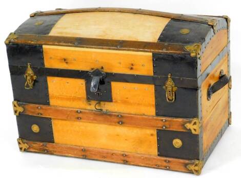 A 20thC dome top trunk, with wooden banding and metal mounts with leather side handles, 49cm high, 72cm wide, 46cm deep.