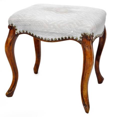 A 19thC stool, the serpentine top overstuffed in a (later) textured blue material, on cabriole legs, 40cm high, 44cm wide, 35cm deep.