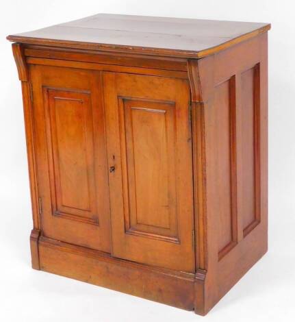 An early 20thC mahogany cupboard, of rectangular form with two panelled doors raised on a block base with panel sides 76cm high, 64cm wide, 48cm deep.