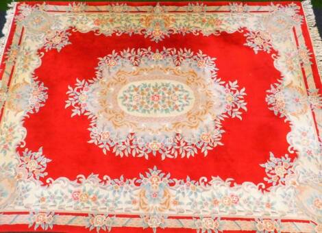 A large Chinese rug, decorated with flowers, predominantly in red, cream and green, with certificate no. 17742 reading, in the opinion of the under mentioned company, valued at £1000, 370cm x 280cm.