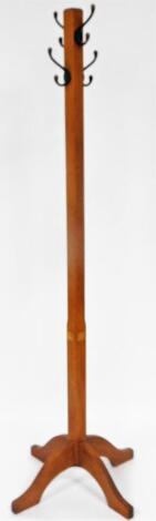 An early 20thC oak Arts and Crafts hat stand, with square block stem and four scroll feet with metal pegs, 180cm high.