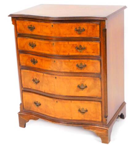 A 20thC walnut serpentine chest, the with a wide crossbanding raised above five graduated drawers, each with plate back swan neck handles on bracket feet, 88cm high, 73cm wide, 45cm deep.