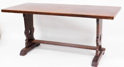 An early 20thC oak refectory table, the rectangular top raised on heavy legs pierced with heart shaped motifs on shaped feet, 76cm high, 168cm wide, 77cm deep.