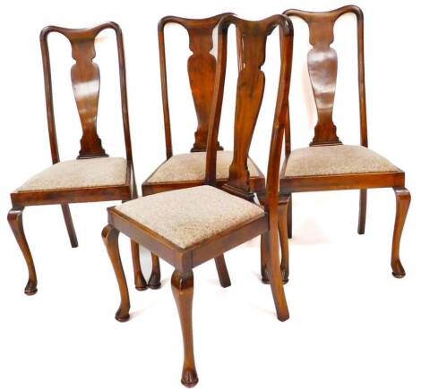 A set of four early 20thC Queen Anne style dining chairs, each with hourglass splats, drop in seats and cabriole front legs terminating in pad feet, 110cm high. (4)