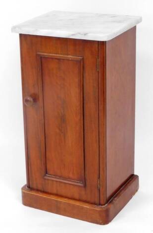 A Victorian mahogany pot cupboard, with later marble top raised above a panelled door on D end base, 75cm high, 39cm wide, 34cm deep.