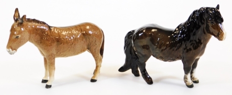 A Beswick figure of a standing donkey, printed marks beneath, 14cm high and an unmarked Shetland pony. (2)