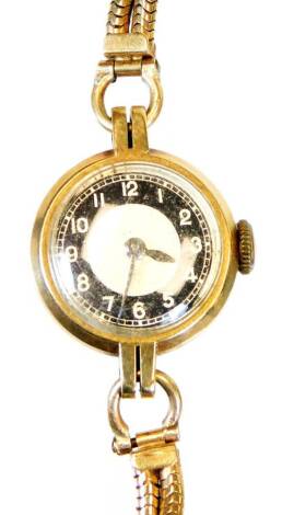 A ladies 9ct gold cocktail watch, with black chaptering, 1.5cm diameter, with Arabic numerals and chain strap marked 9.375, 15.2g all in.