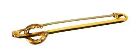 A horseshoe type pin, with plain stick surmounted by a horseshoe, with plain pin back, marked 9ct, 5cm wide, 1.5g all in.