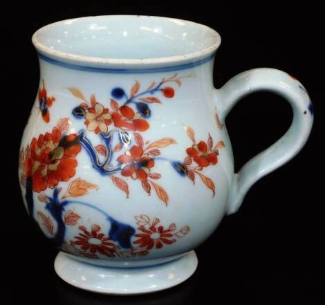 An 18thC Chinese Imari baluster mug with ear handle, predominantly decorated in orange and blue with a bird amongst trees, marked, 12cm high.