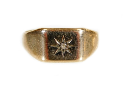 A 9ct gold signet ring, with star emblem centred by small white stone, size S, 4.1g all in.