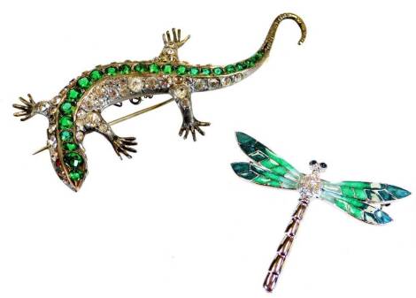 An Art Deco style lizard brooch, set with green glass sections to the back, with plain pin fastener, 8cm wide, and an Art Deco style dragonfly brooch. (2)