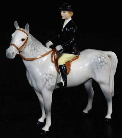 A Beswick black jacketed huntswoman on grey horse, 23cm high. (AF)