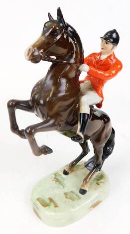 A Beswick 868 rearing huntsman, red jacket, on unusual sponged base, lacking Beswick mark, 25cm high.