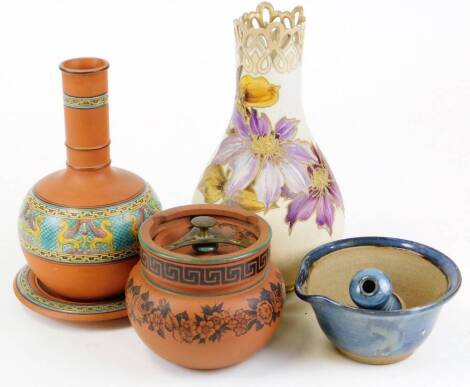 An early 20thC Doulton Carrara pattern vase, decorated with flowers with a pierced top, 28cm high, red ware bottle vase and cover, and a further red ware tobacco jar and cover, etc. (a quantity)