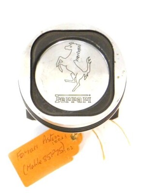 A Ferrari piston head, Mahle 85P75, embossed with prancing horse and Ferrari, 5.5cm H, 8.5cm Dia.