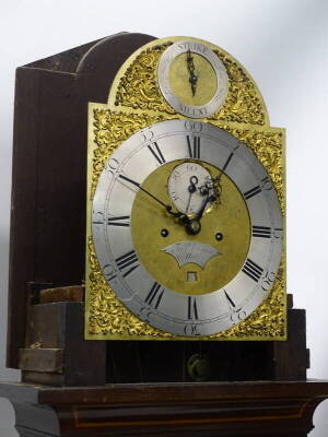 Francis Dusgate, Holt. A late 18th/early 19thC longcase clock, the arched dial with silvered chapter ring, subsidiary seconds and date aperture, elaborate rococo scroll spandrels, eight day four pillar movement, inlaid mahogany case, on ogee bracket feet - 2